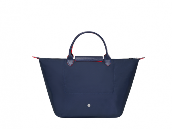This lightweight handbag, both light and durable, can hold your laptop or documents. It features classic clean lines and a feminine touch. With its two handles and snap closure, you can carry it by hand or fold it up into the size of a paperback book in the blink of an eye. Longchamp drew its inspiration from origami when creating LE PLIAGE, a light, foldaway bag that has since become a cult object worldwide. Here, the brand has updated its emblematic LE PLIAGE line with a collector's version in a collegiate and casual spirit. The nylon canvas is decorated with tone-on-tone Russian leather trimming and features an embroidered Longchamp horse as a signature. The ultimate PLIAGE CLUB detail: its colored snap-fastening button matching the embroidery and the colors of its edges, accentuating the contrast effect.